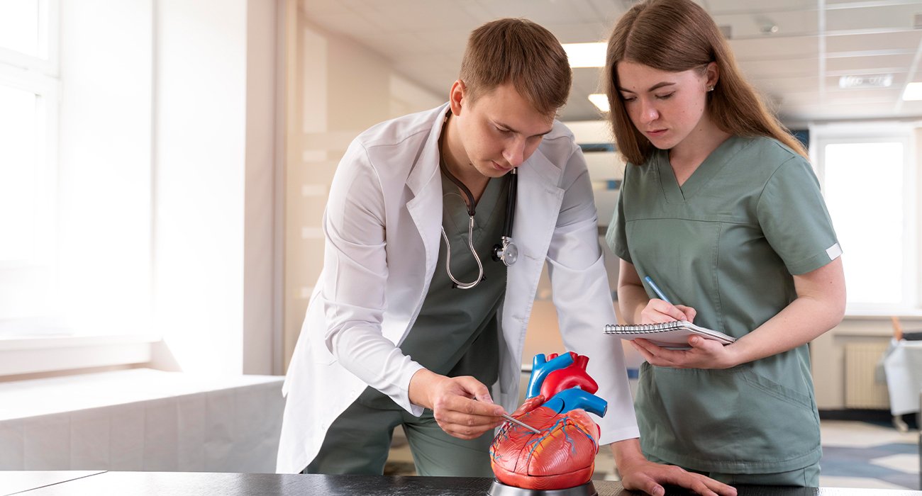 Medical illustration demonstrating the MitraClip procedure, showing the device repairing a leaky mitral valve in the heart.